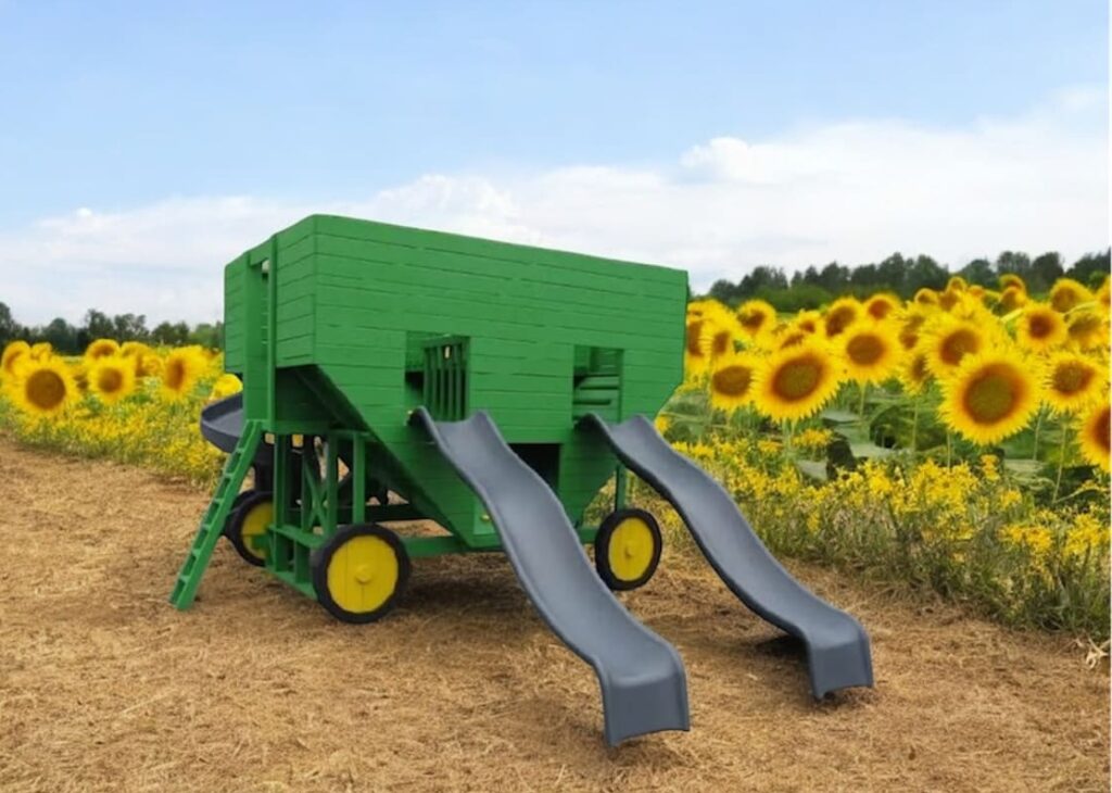 Grain Wagon Kinzerbilt Playset with slides next to a sunflower field.